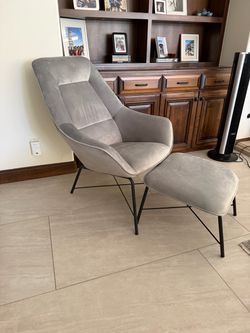 Modern gray chair and footrest.