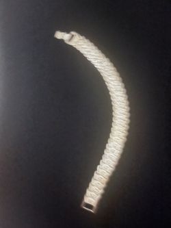 Elegant silver-toned bracelet with a textured chevron link design. This piece is made of a metallic material with a bright silver finish. Each link ha