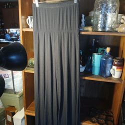 black, wide-leg, high-waisted palazzo pant with a ruched elastic waistband.