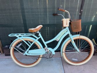 Mint  green Huffy bicycle Nel Lusso Girls' Cruiser Bike with 24-inch wheels.