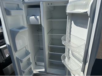 Glossy white Frigidaire side-by-side refrigerator with water and ice