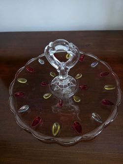 Glass tidbit tray with candlestick holder featuring red and yellow teardrop decorations by Indiana Glass Company