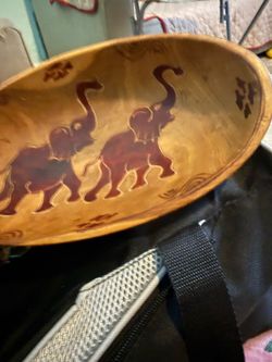 Hand-carved wooden decorative bowl with elephants