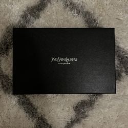 This is a Saint Laurent Cassandre Envelope Chain Wallet in black chevron quilted leather