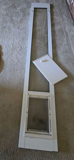 Doggie door with removable shutter. Also black fence.