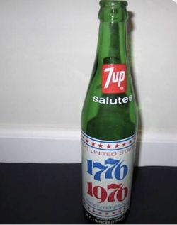 2 vintage 7 up bottles with original caps