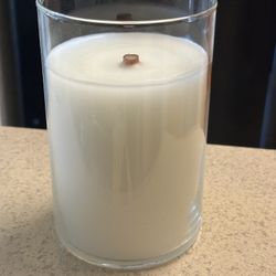 White Woodwick Candle In Clear Round Container.