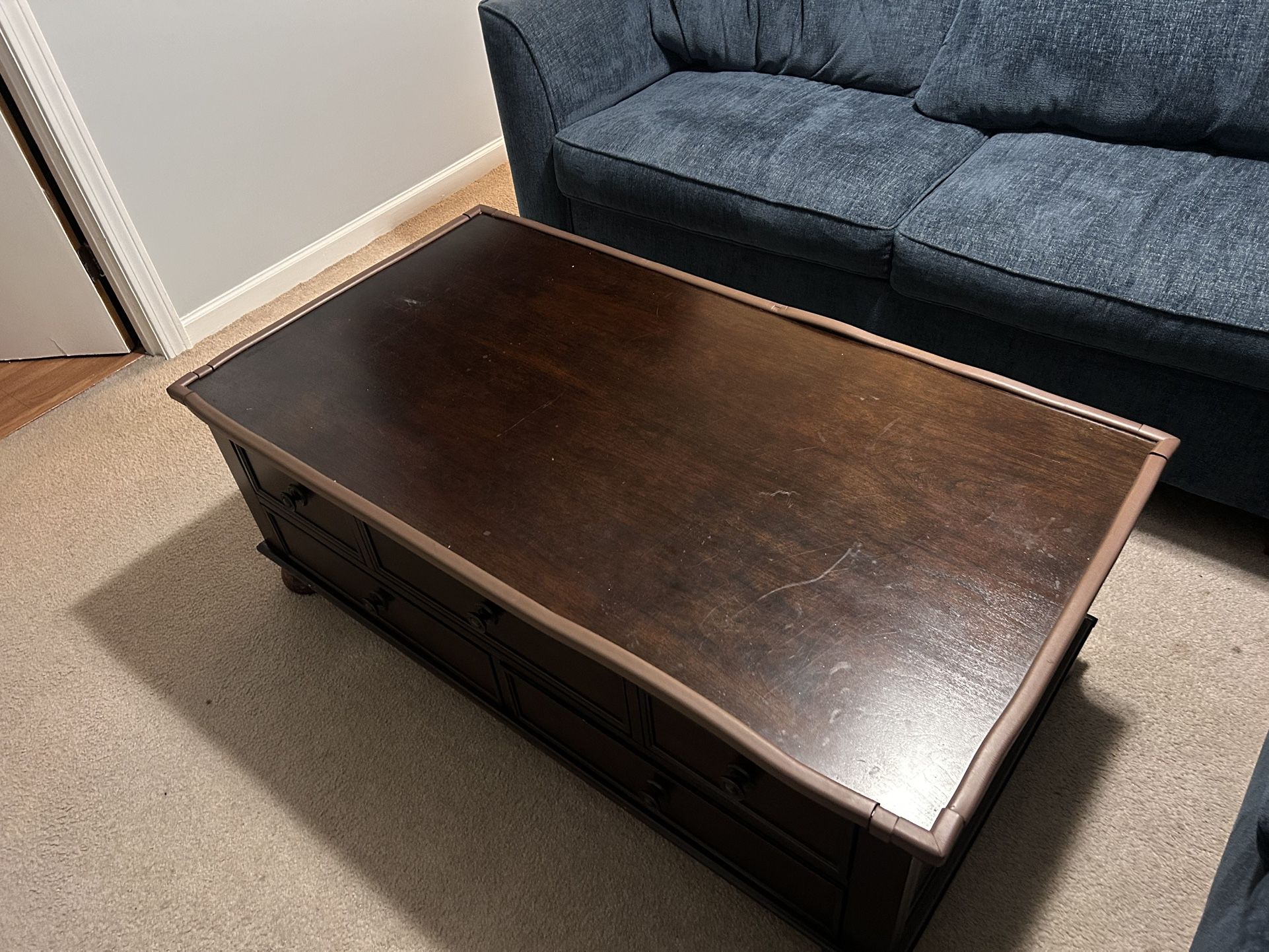 Oak coffee table with five drawers and safety bumpers