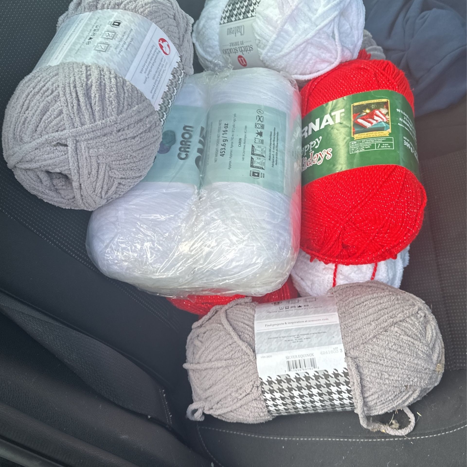 ten rolls of brand new yarn stitch studio white / grey / red selling all ten rolls for price shown 
