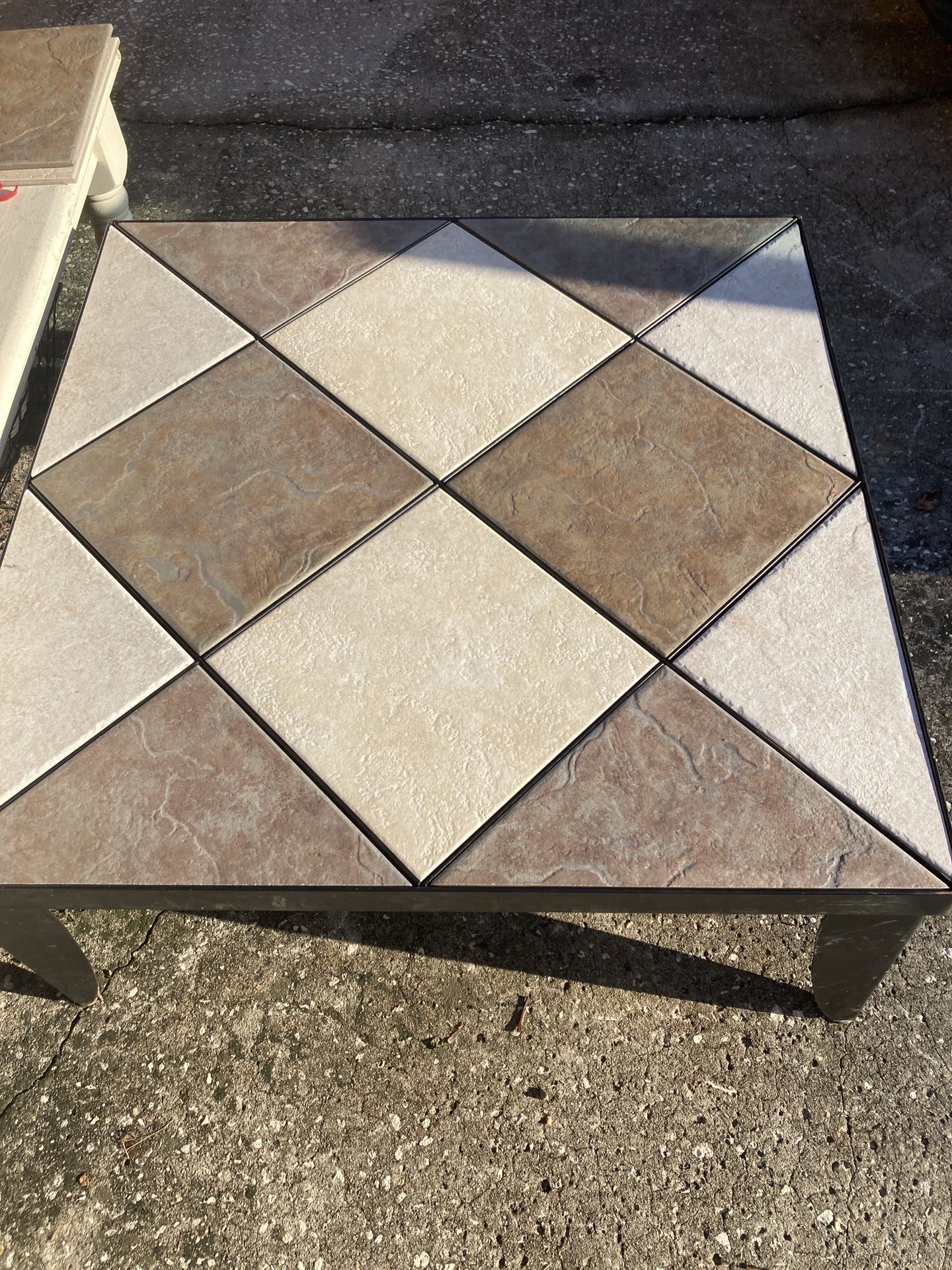 Unique coffee table with metal frame and legs and removable tiles to create your own design