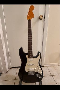 Dark brown Strat style guitar