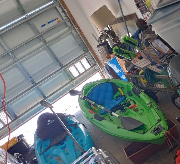 2 kayaks one fishing and one ocean paddles wheels to pull