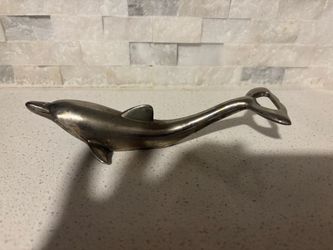 Antique dolphin bottle opener