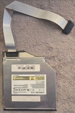 Toshiba TS-L462 slim laptop optical drive with attached ribbon cable.