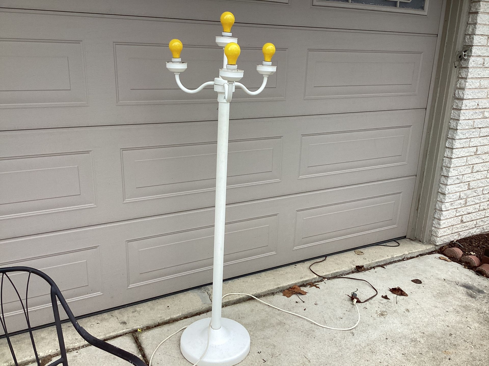 Electric outdoor/ indoor lamp post with 4 lights use standard bulbs 62 tall switch 3 setting ..globes come with it,weighted base for outdoor use ..