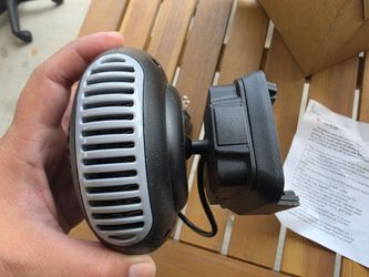 Portable 12V-style car heater/defroster with adjustable mounting base. Great for helping defrost or defog your windshield in cold weather. Includes ba