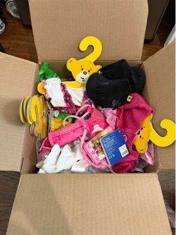 Box of build a bear accessories with hangers