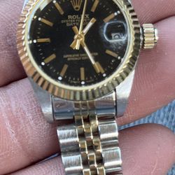 The image shows a pre-owned ladies' Rolex Datejust 26mm wristwatch, featuring a stainless steel and 18K yellow gold Jubilee bracelet. This model, refe
