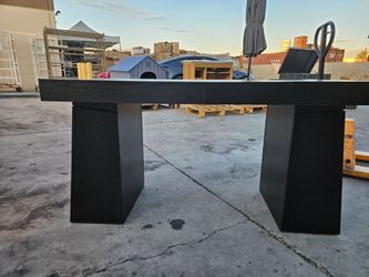 Black table with minor damage.