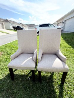 Selling a large pair of dining chairs in a light color.