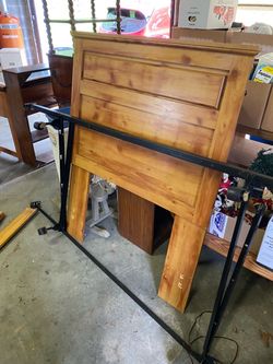 Twin bed with wooden head board and metal fram