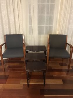 2 wooden chairs with 3 layered coffee tables