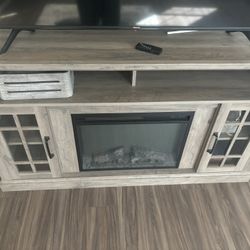 tv stand with built in electrical fire place ( TV not included )