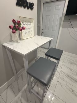 Two stools with a high top table
