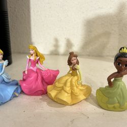 Disney figurines princesses  & 1 is a mcdonalds disney figurine the larger item