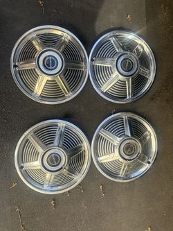 Early Mustang set up four hubcaps