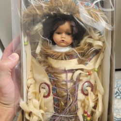 Is Porcelain Doll with Certificate of Authenticity.