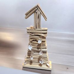 Driftwood Lighthouse W/ Shells  16” Tall. one of the shells is chipped and the sting is loose at the bottom 