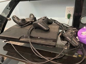 PS3 with controllers and games