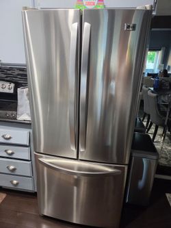 LG stainless steel side by side refrigerator.