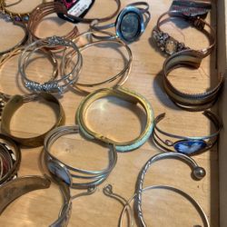 A large tray, full of costume, bracelets, and cuffs bracelets