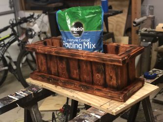 Wooden garden box with potting soil