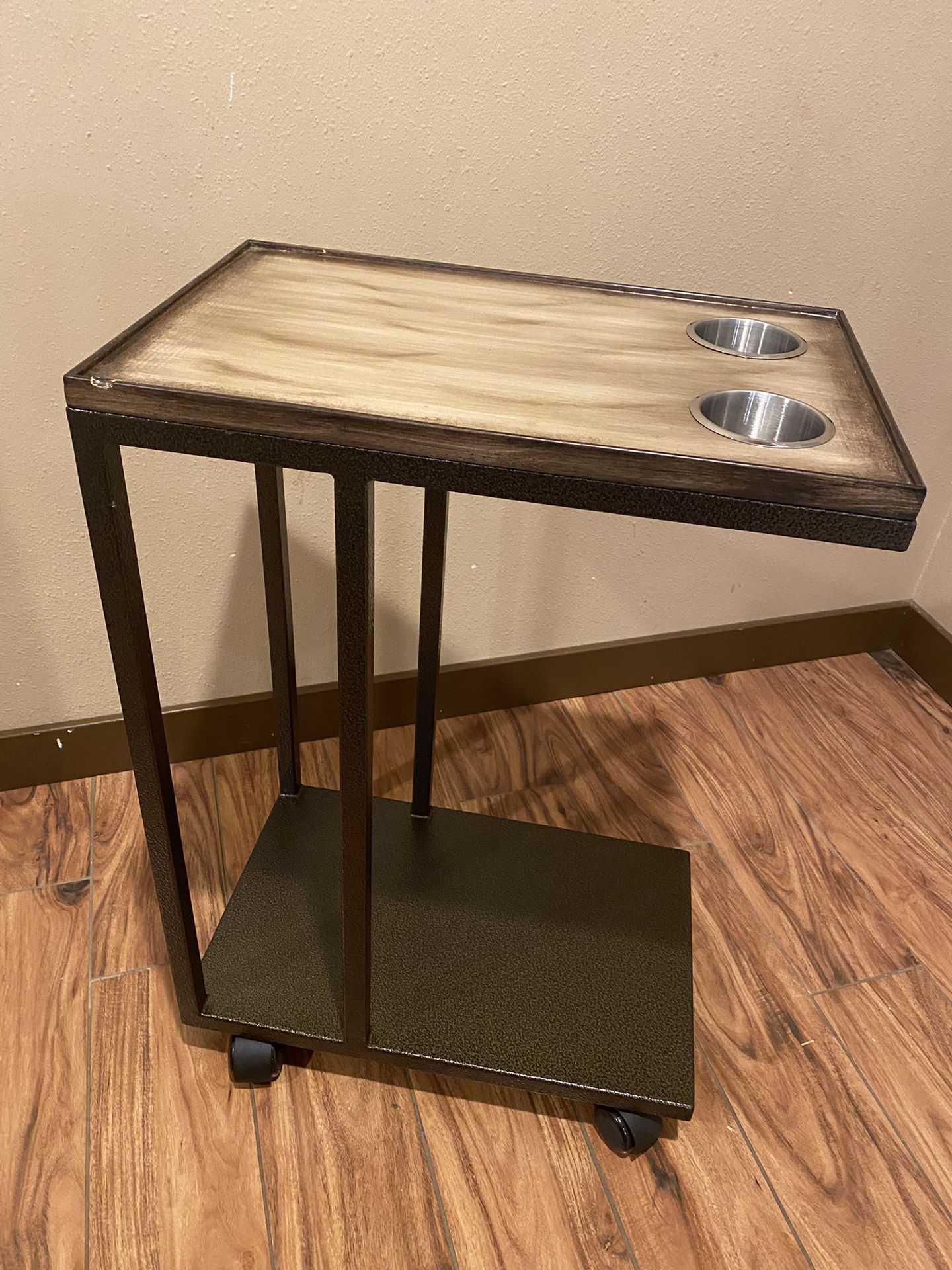 Beverage And Service Cart with Cut Outs for Cup Holders. The casters make it easy to roll to wherever you would like. Durable metal base. 28”H - 12”W 