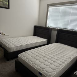 Two beds with twin size mattresses.