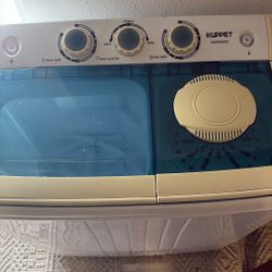 A small, new, never-used twin-tub washing machine, ideal for small families or those with a young child.