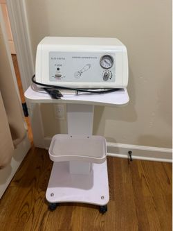 Microdermabrasion machine with rolling cart