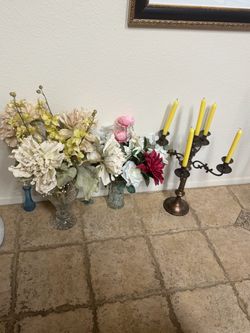 Vases with artificial flowers and candle holder