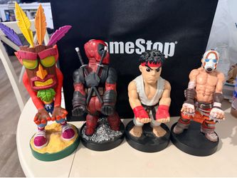 Cable guys controller/phone holding statues