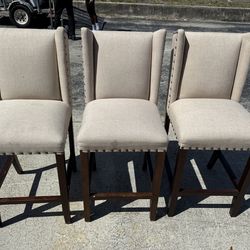 Three wing back upholstered bar, stools, nail head trim