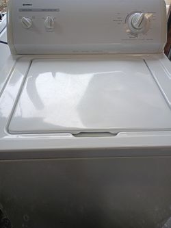 White Kenmore top load washing machine. Has super capacity for bigger loads and heavy duty cycles. You can pick water level and wash temp. Works great