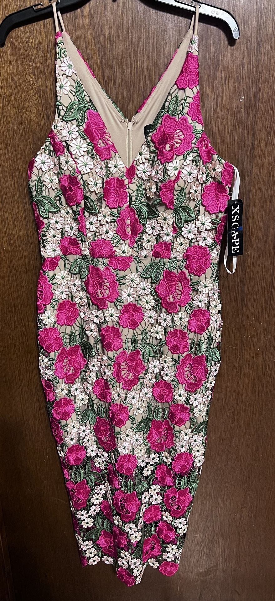 A garden-like layer of colorful lace decorates this curve-hugging midi dress from XSCAPE. A plunging V-neckline adds extra drama to the mix.