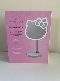 Impressions Vanity Hello Kitty Rechargeable Table Makeup Mirror is shaped after Hello Kitty and outlined with an ultra-bright LED strip light.