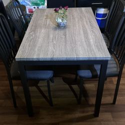 Gray Table with 4 chairs in good condition.
