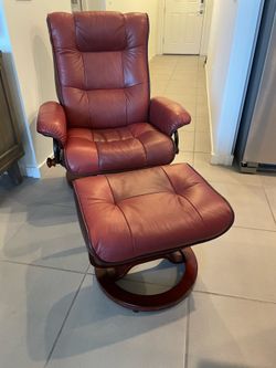 Two leather reclining chairs and ottomans.