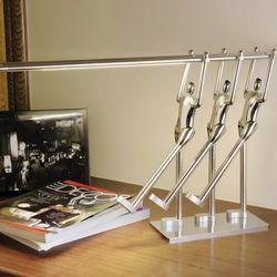decorative stainless steel bookend featuring a kinetic human figure design.
