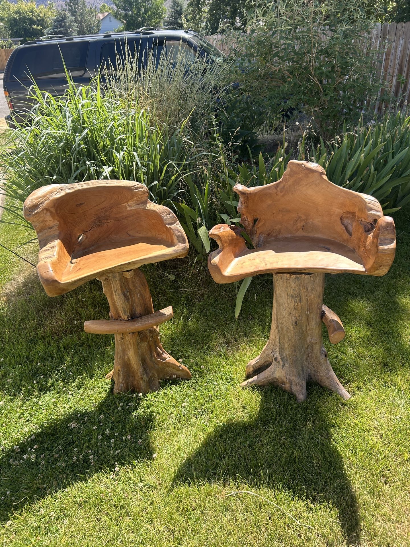 Two carved wood barstools